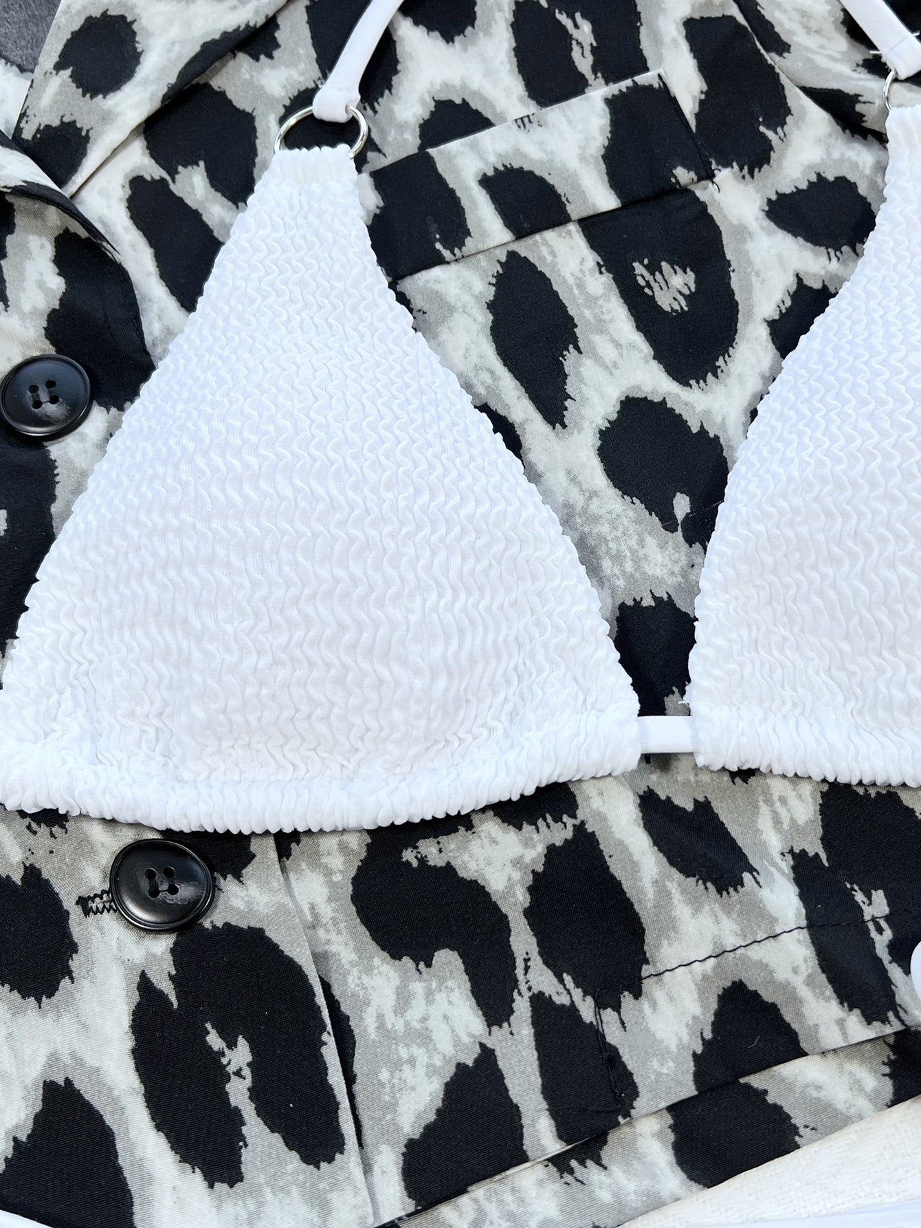 The Dune Bikini in white — close flat-lay of the textured triangle top and tie-side bottoms
