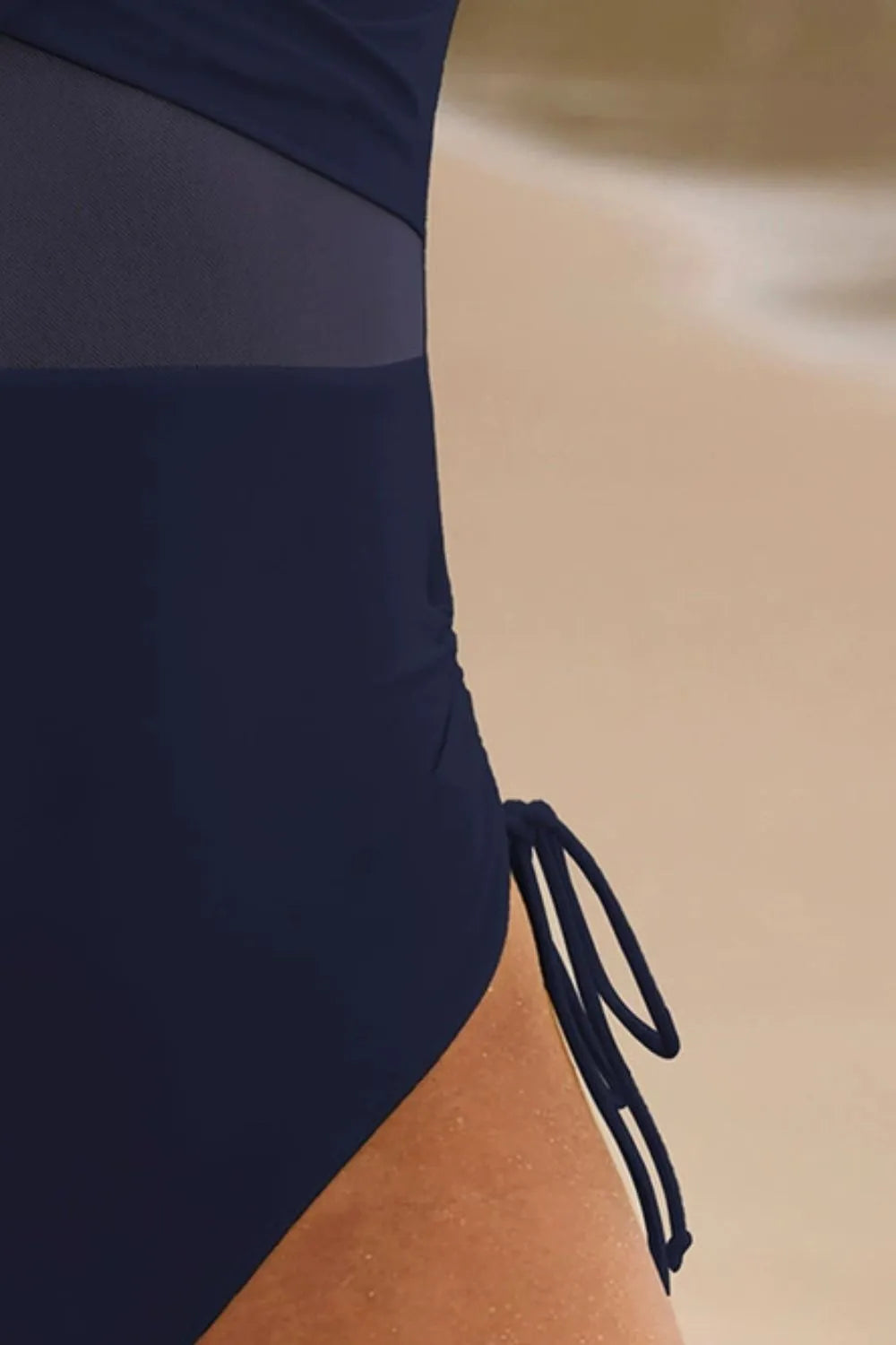 The Drift One-Piece navy one-piece swimsuit, sheer mesh panel across the waist